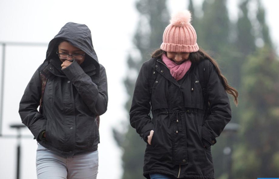 epa07991817 People walk on a rainy day in Saltillo, Mexico, 12 November 2019, where temperatures were expected to drop as low as two degrees Celsius. The temperature in some regions of Mexico dropped due the cold front number 12, according a state media report. EPA-EFE/Miguel Sierra